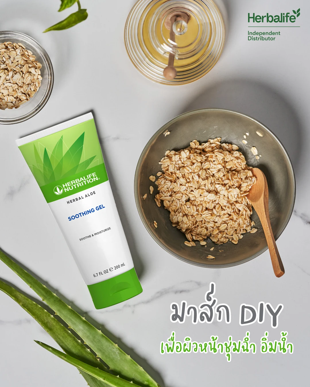 หลอดเจลสีเขียวขาว ชามข้าวโอ๊ตกับช้อนไม้ โถน้ำผึ้ง และใบว่านหางจระเข้บนโต๊ะหินอ่อน