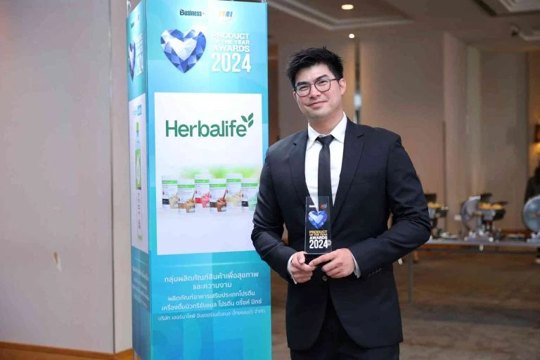 Company representative holding the Product of the Year Awards 2024 trophy
